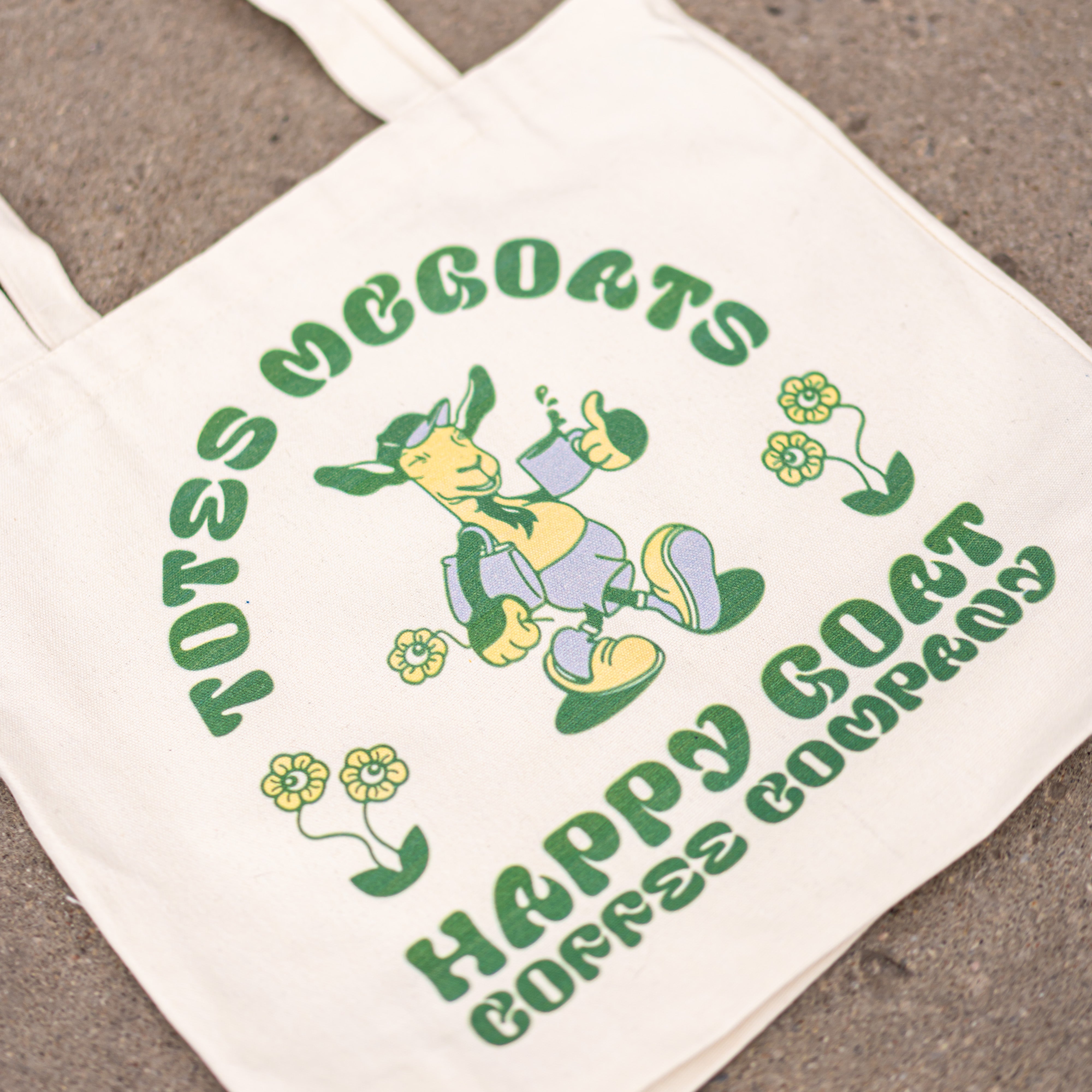 Happy Goat  Coffee Tote Bag displayed on ground